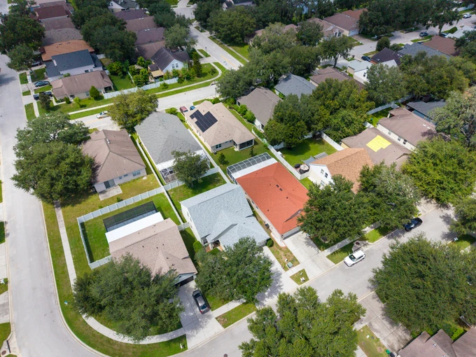 Oblique aerial view of a residential street and neighboring homes