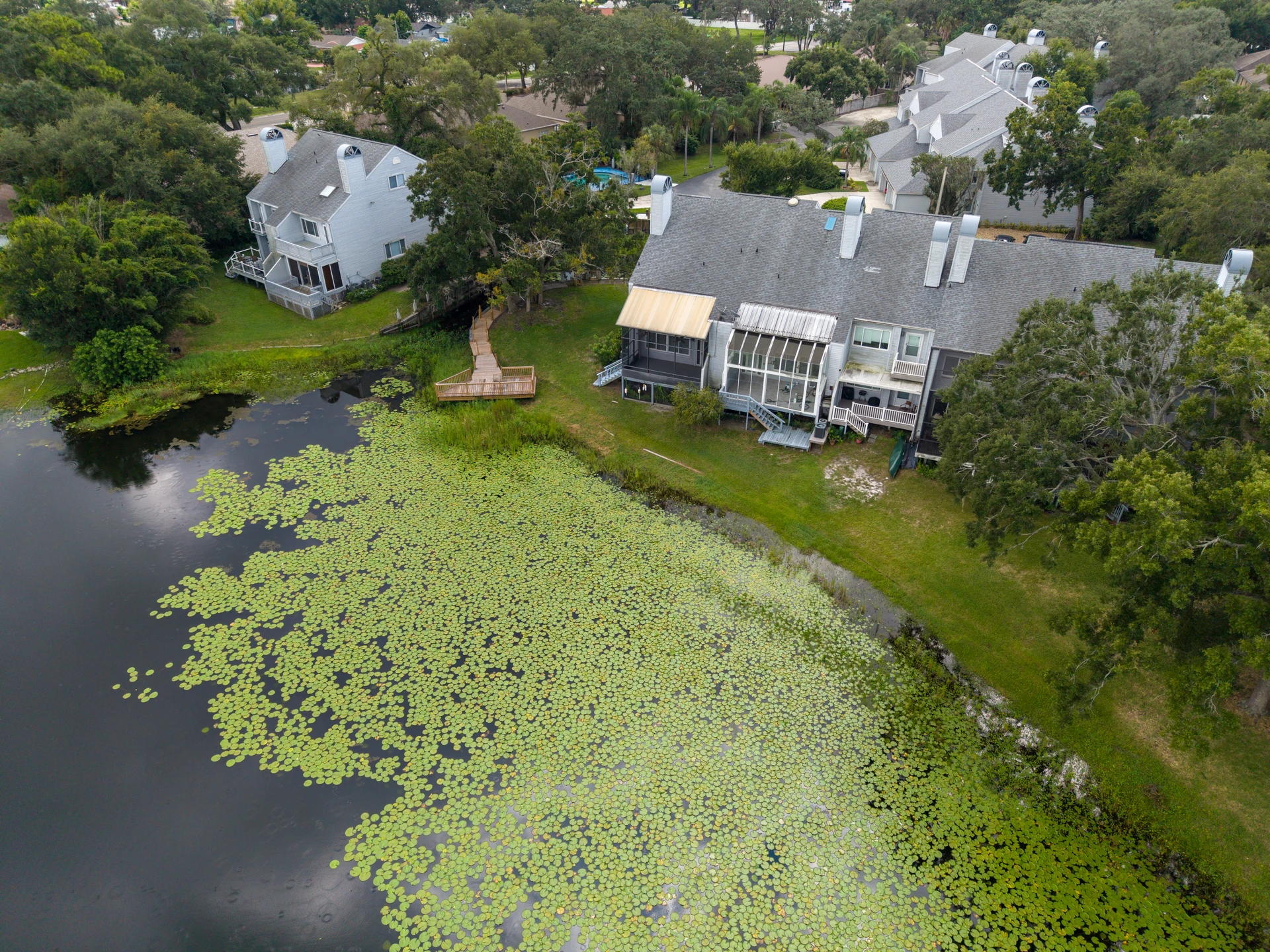 Lakeside house reflected in a pond bordered by vegetation