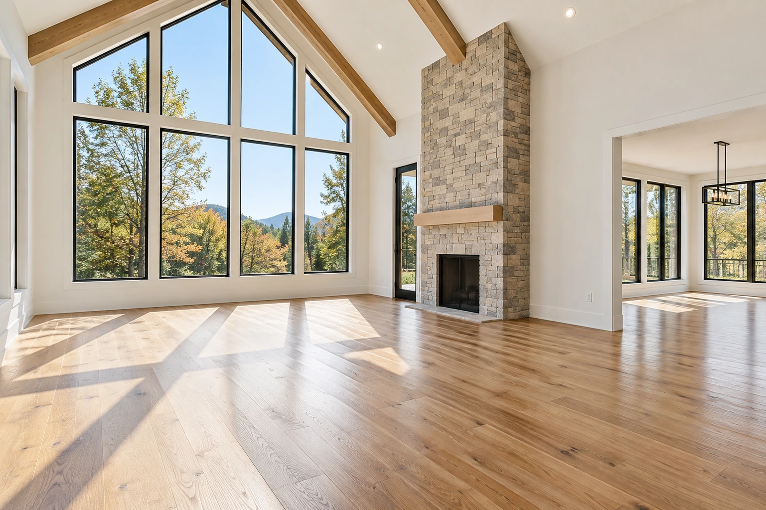 Completely vacant sunlit architectural room with warm oak floors, large windows and clean white walls, no furniture