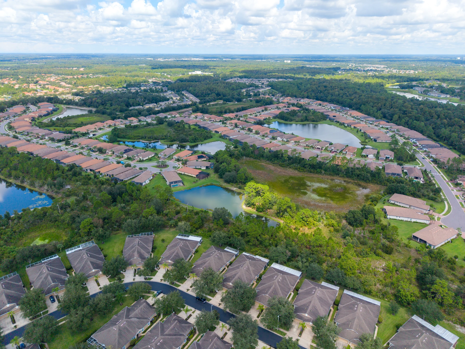 Aerial view of a residential community surrounded by trees